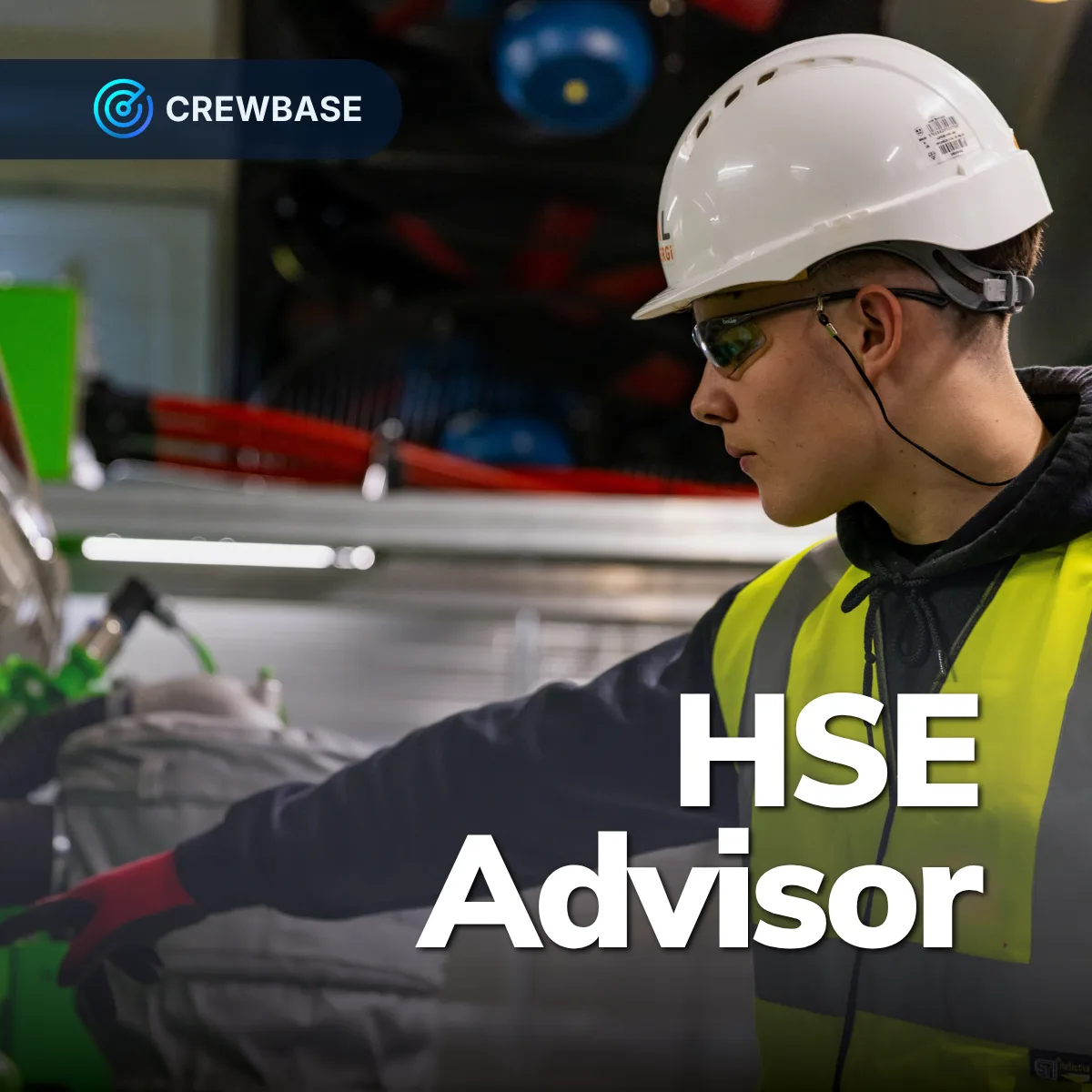 HSE advisor in white hard hat and hi-vis pointing on deck with CrewBase HSE Advisor text