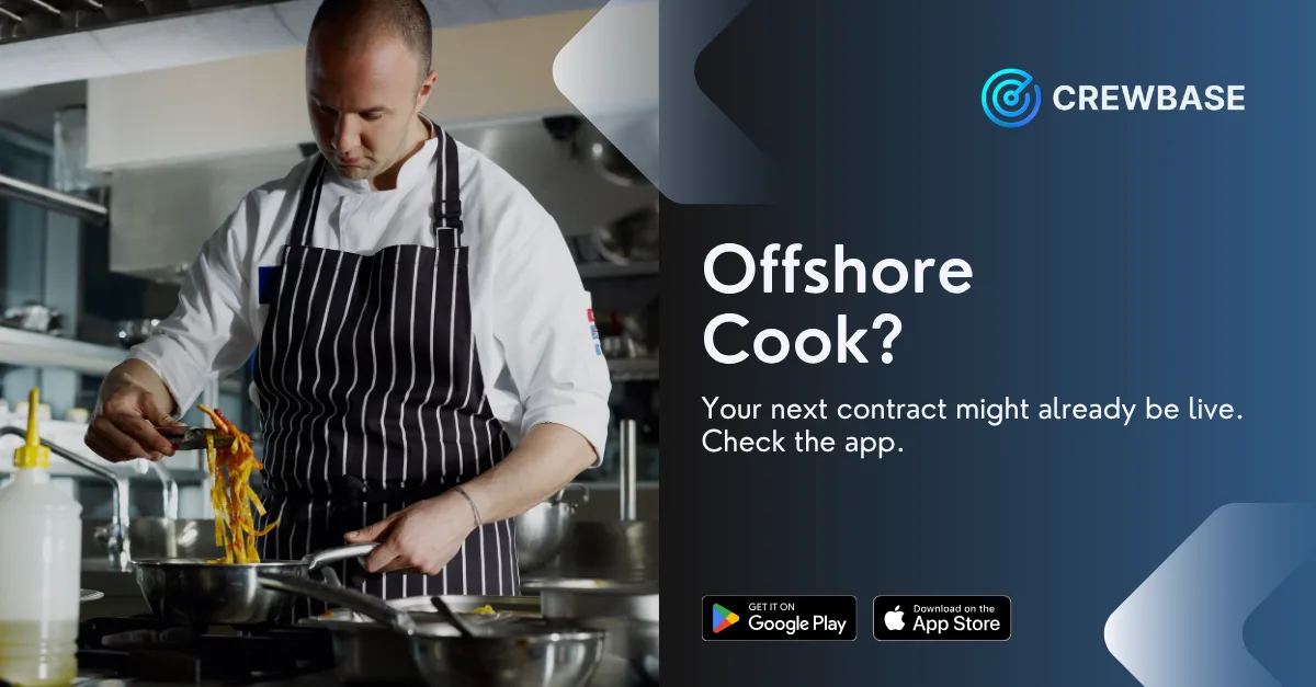 Professional chef in galley cooking with CrewBase offshore cook recruitment banner