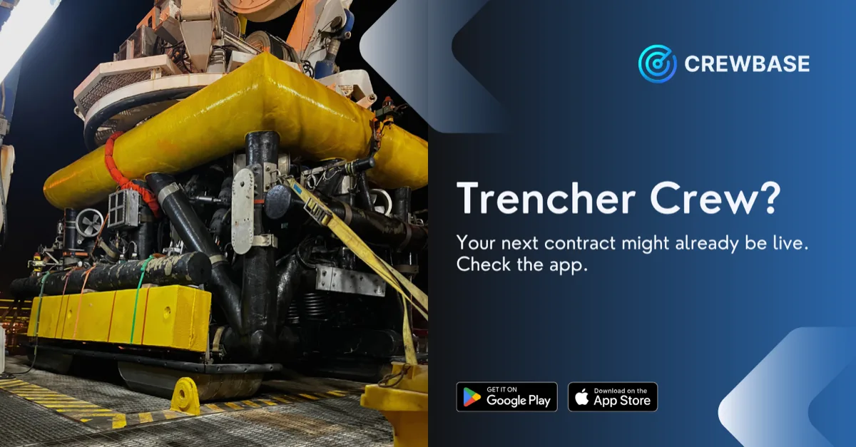 Industrial trencher equipment on vessel deck at night with CrewBase trencher crew recruitment banner